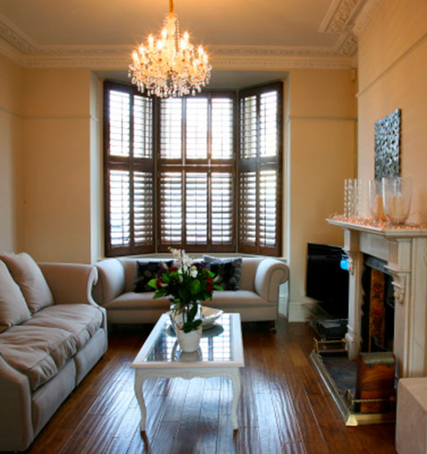 classic wooden floors into bay window with matching shutters